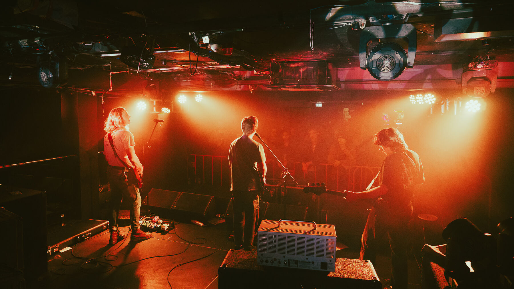 Band on stage under red lights